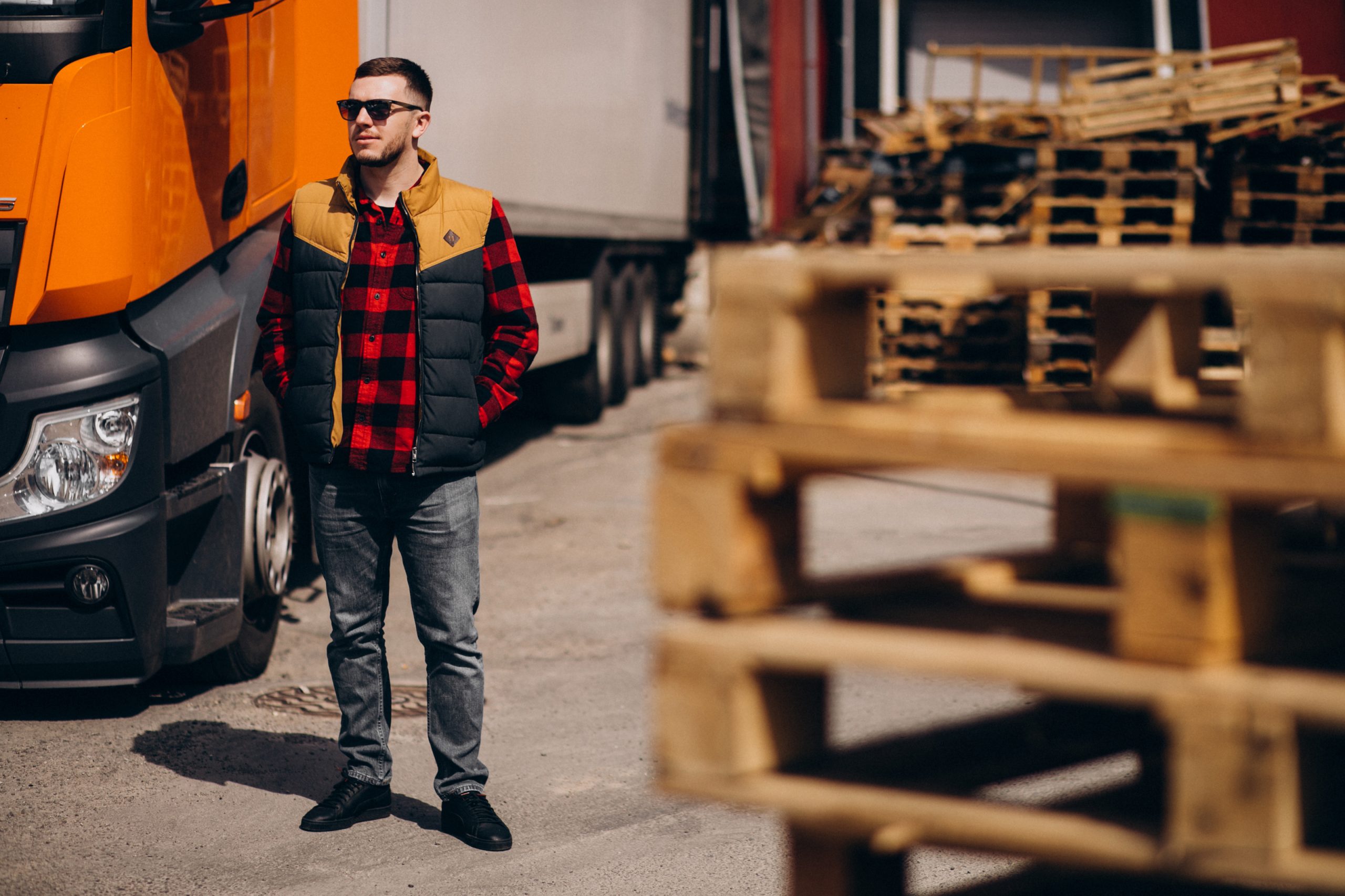 Handsome man truck driver standing by the truck
